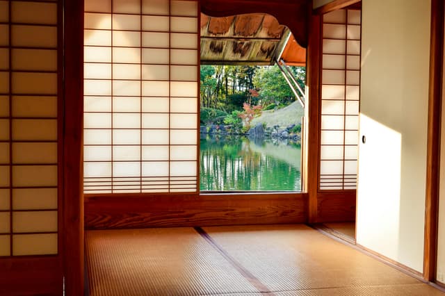 Traditional Japanese ryokan room with tatami mats and sliding shoji doors